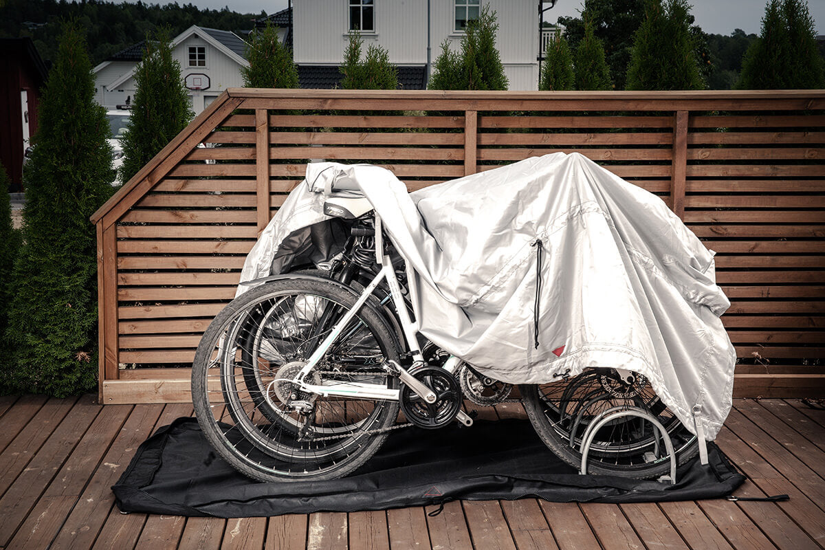 De bovenhoes van Bag'in wordt over fietsen op een houten vlonder getrokken